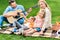 happy family playing guitar and sitting together on plaid