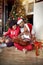 Happy family playing guitar songs in front of a decorated Christmas tree