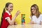 A happy family playing a round of Jenga with their lovely daughters. Mother and daughters have fun playing the tower game.