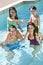 Happy Family Playing In A Swimming Pool