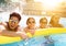 Happy family playing in swimming pool