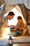 Happy family playing with toy in kids tent at home