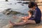 Happy family playing water sea on the beach.