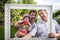 Happy family portrait of cheerful grandfather with his daughter and grandchild during outdoors party