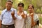 Happy Family portrait - Senior Retired parents and their daughter showing the inked finger after voting in Indian elections in an