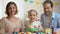 Happy family posing at camera with Easter basket, ancient tradition, celebration