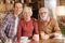 Happy family posing while having breakfast in the kitchen