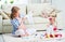 happy family pregnant mother and child daughter preparing clothing for newborn baby