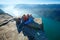 Happy family on Preikestolen massive cliff top (Norway)