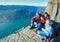 Happy family on Preikestolen massive cliff top (Norway)