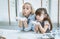 A happy family is preparing bakery together. Mother and daughter sitting at the kitchen table, a cute Blowing flour to make