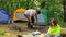 Happy Family Preparing For Picnic At Campsite