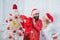 Happy family preparing to new year. Christmas holiday party. Red lingerie for Christmas women. Santa claus in modern red