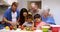 Happy family preparing vegetables