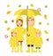 Happy family in raincoats with umbrella falling leaves