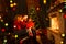 Happy family reading book at home by fireplace in warm and cozy living room on winter day christmastime