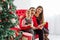 Happy family reads a book near a Christmas tree