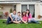 Happy family relaxing in backyard of new home