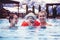 Happy family relaxing in the spa center with a child swims in the pool