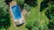 Happy family relaxing by swimming pool, aerial drone view from above of parents and kids have fun on vacation, family weekend