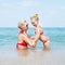 Happy family resting at beach in summer