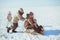 Happy family ride on a sledge in winter