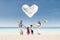 Happy family run at beach under love cloud