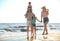 Happy family on sandy beach near sea