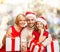 Happy family in santa helper hats with gift boxes