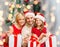 Happy family in santa helper hats with gift boxes