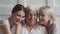 Happy family senior old parents and young adult daughter embracing