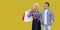 Happy family after shopping, adult man and woman in casual checkered shirt standing together and holding paper bag with toothy