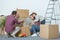 happy family signing boxes while moving