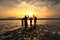 Happy family in silhouette enjoy beautiful sunrise on the beach