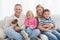 Happy family sitting with pet kitten together