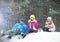 Happy family sledding in forest