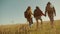 Happy family slow motion video walking on nature boy girl and mom in a field on trekking trip. tourists with backpacks