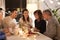 Happy family with smartphone at tea party at home