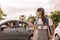 Happy family smiling on a routine morning school. School girl walks away from the car on a sunny day