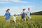 Happy family smiling running on the field in nature