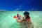 Happy family splashing in green lagoon on a tropical resort