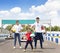 Happy family standing on the go kart race track