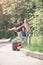 Happy family with suitcase traveling hitchhiking