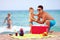 Happy family on summer beach picnic