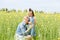 Happy family on a summer meadow. little girl child daughter hugging and kissing mother.Yellow field of rapeseed flowers