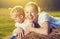 Happy family in summer nature. Mother and baby daughter in the hay, straw