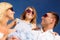 Happy family in sunglasses over blue sky