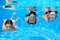 Happy family swim underwater in pool