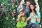 Happy family on swing look toward near hedge