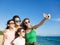 Happy family taking a selfie at the beach